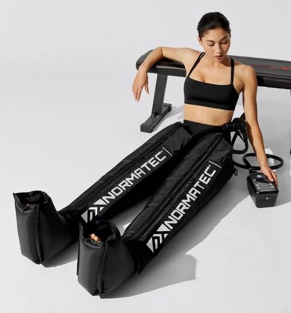 Woman in Normatec Compression suit.  NormaTec and the Benefits of Compression Therapy.